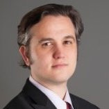 A person wearing a suit and tie Description generated with very high confidence